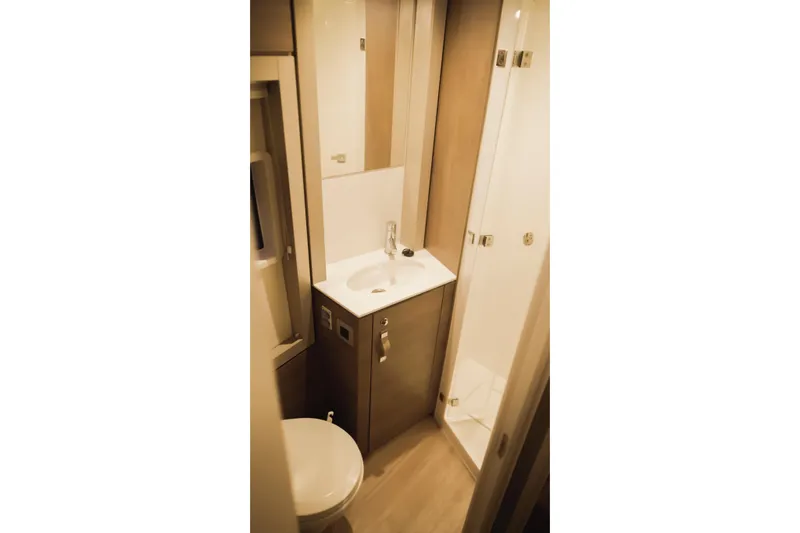 Point Clear Yacht Photos Pics Compact bathroom in 2023 Bali 4.4 model, featuring sink, toilet, and shower.