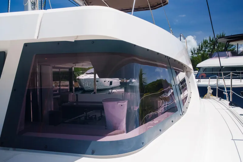 Point Clear Yacht Photos Pics 2023 Bali 4.4 yacht with sleek design and reflective windows in marina setting.