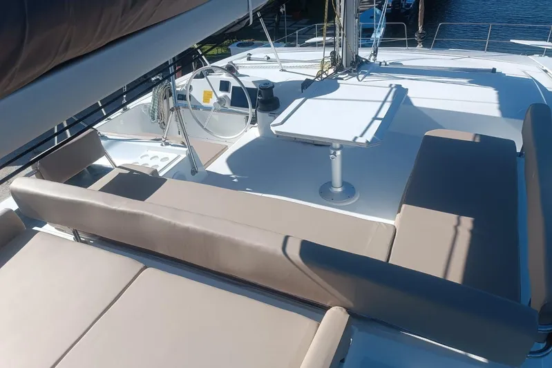 Point Clear Yacht Photos Pics Luxurious 2023 Bali 4.4 yacht deck with seating and steering wheel.