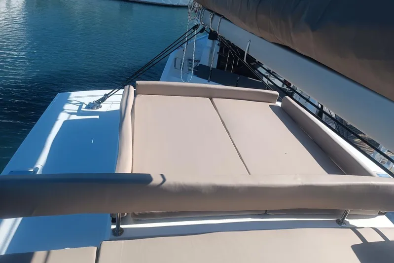 Point Clear Yacht Photos Pics Luxurious sunbathing area on 2023 Bali 4.4 yacht, overlooking serene blue waters.