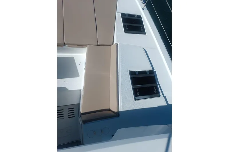 Point Clear Yacht Photos Pics 2023 Bali 4.4 yacht deck with beige seating and storage compartments.