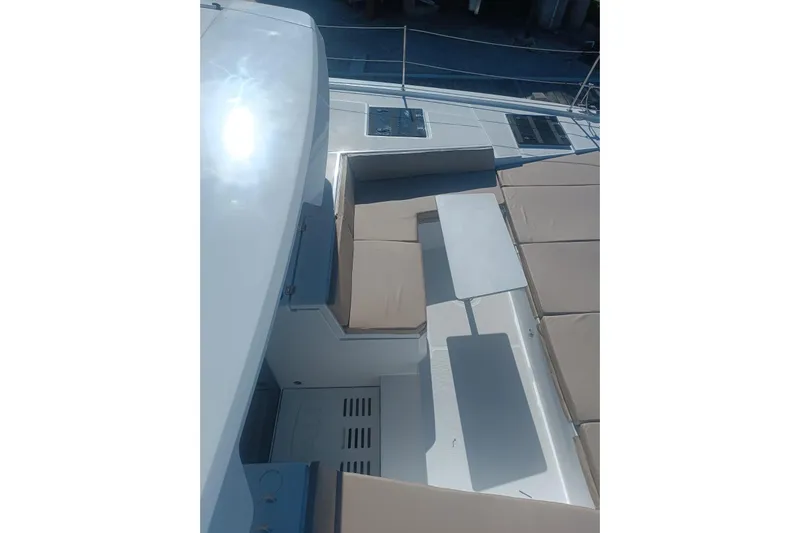 Point Clear Yacht Photos Pics 2023 Bali 4.4 yacht deck with seating and table, featuring modern design and sunlit surfaces.