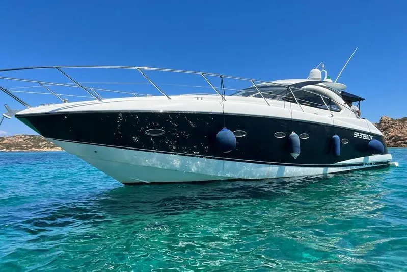  Yacht Photos Pics 2006 Sunseeker Portofino 47 yacht on clear blue water, sunny day.