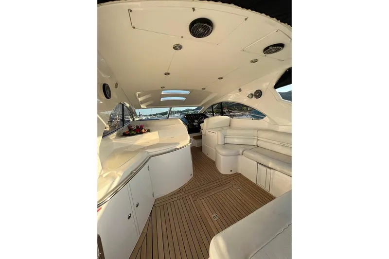  Yacht Photos Pics Luxurious interior of a 2006 Sunseeker Portofino 47 yacht with elegant seating and wood flooring.