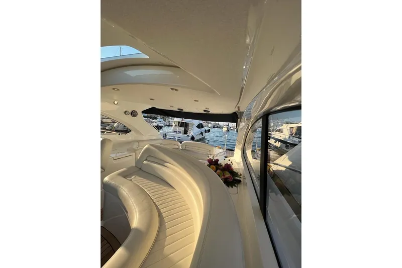  Yacht Photos Pics Luxurious interior of 2006 Sunseeker Portofino 47 yacht with elegant seating and marina view.