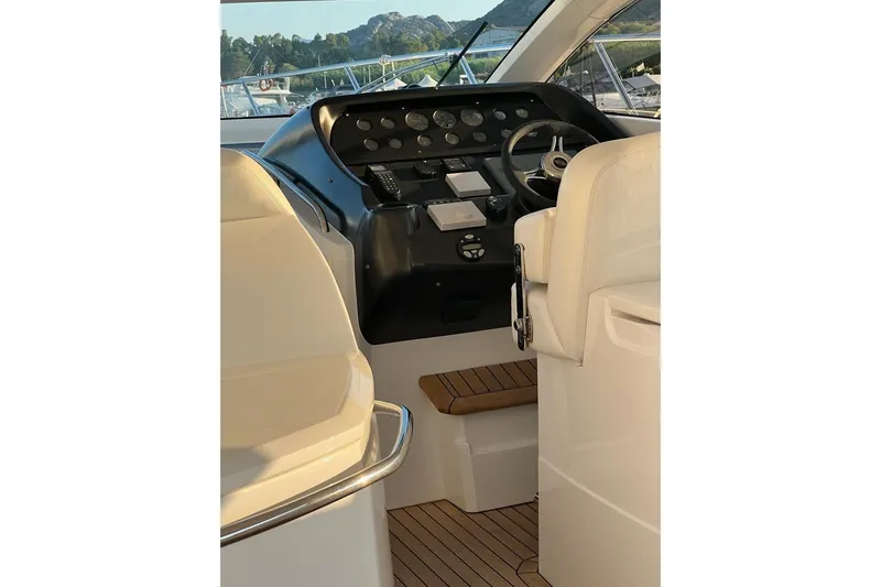  Yacht Photos Pics Helm of 2006 Sunseeker Portofino 47 yacht with steering wheel and control panel.