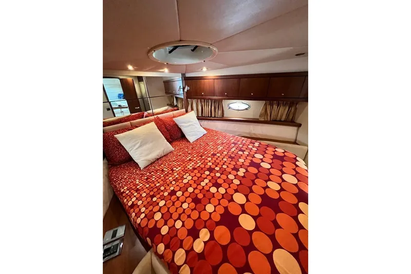  Yacht Photos Pics Luxurious cabin interior of 2006 Sunseeker Portofino 47 yacht with vibrant bedding.