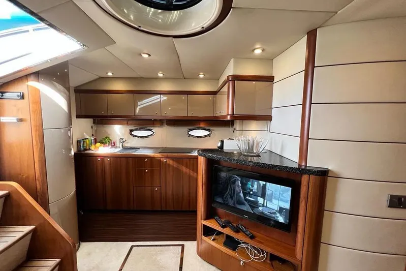  Yacht Photos Pics Luxurious interior of 2006 Sunseeker Portofino 47 yacht with modern kitchen and entertainment area.
