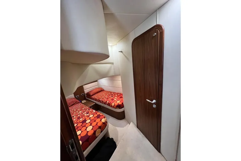  Yacht Photos Pics Interior cabin of 2006 Sunseeker Portofino 47 yacht with twin beds and wooden door.