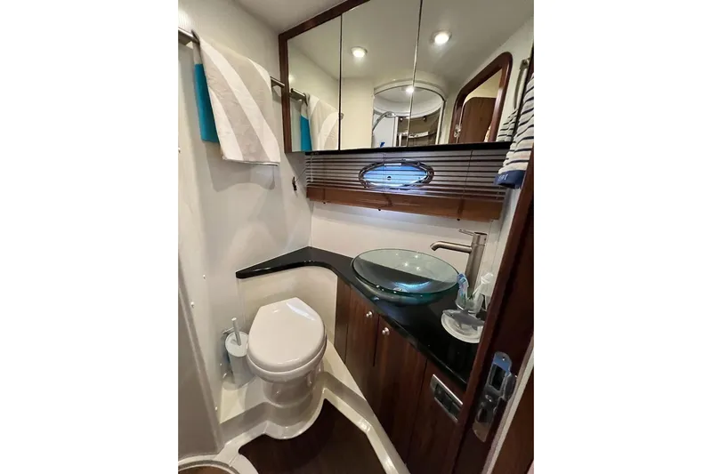  Yacht Photos Pics Luxurious bathroom in 2006 Sunseeker Portofino 47 yacht with modern fixtures and elegant design.