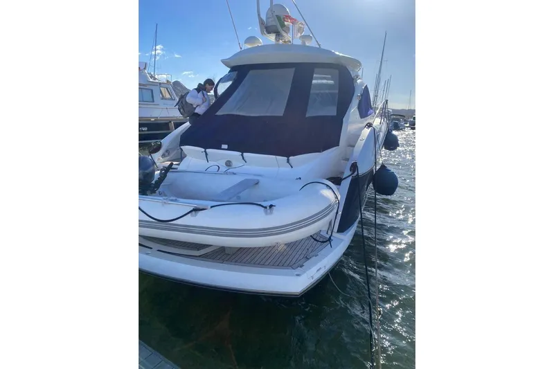  Yacht Photos Pics 2006 Sunseeker Portofino 47 yacht docked, featuring sleek design and inflatable tender.