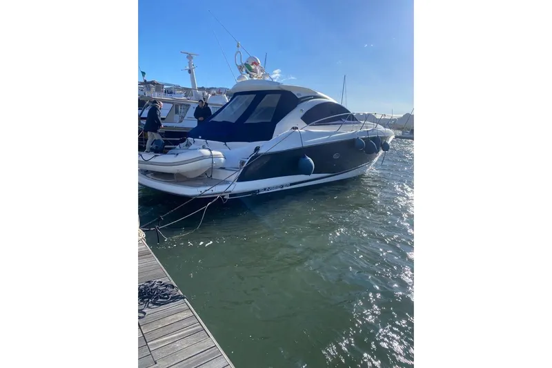  Yacht Photos Pics 2006 Sunseeker Portofino 47 yacht docked in sunny marina.