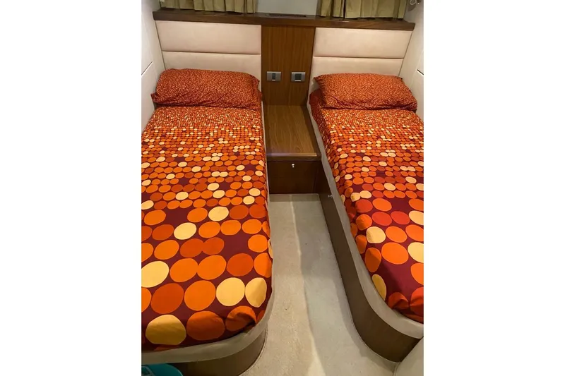  Yacht Photos Pics Twin beds with vibrant orange polka dot bedding in 2006 Sunseeker Portofino 47 yacht cabin.
