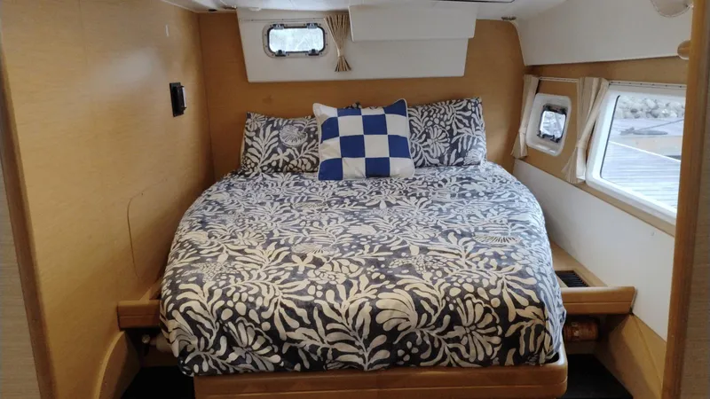 Moon Pearl Yacht Photos Pics Cozy bedroom in 2008 Lagoon 420 yacht with floral bedding and nautical decor.