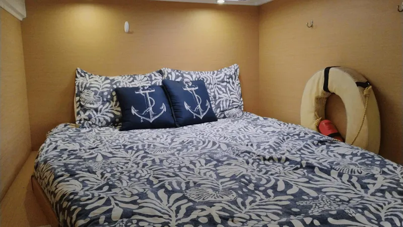Moon Pearl Yacht Photos Pics Cozy cabin bedroom in 2008 Lagoon 420 yacht with nautical-themed bedding and decor.