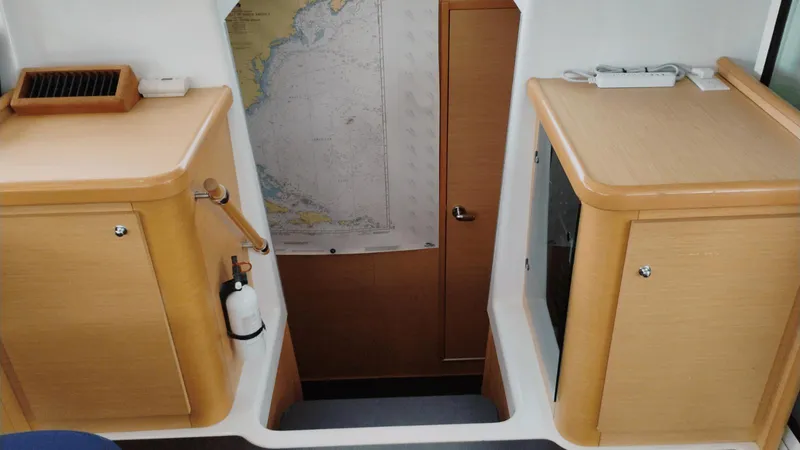 Moon Pearl Yacht Photos Pics Interior of 2008 Lagoon 420 yacht with wooden cabinets and nautical map.