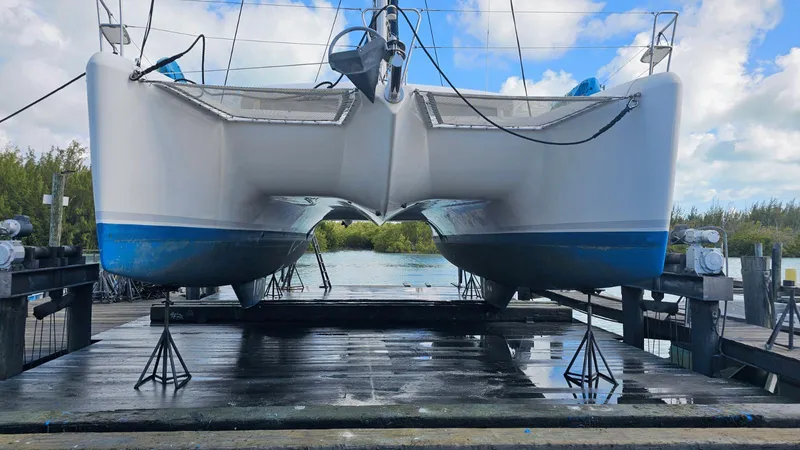 Moon Pearl Yacht Photos Pics 2008 Lagoon 420 catamaran on a dock, ready for maintenance.