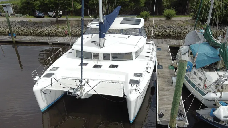 Moon Pearl Yacht Photos Pics 2008 Lagoon 420 catamaran docked at a marina, viewed from the front.