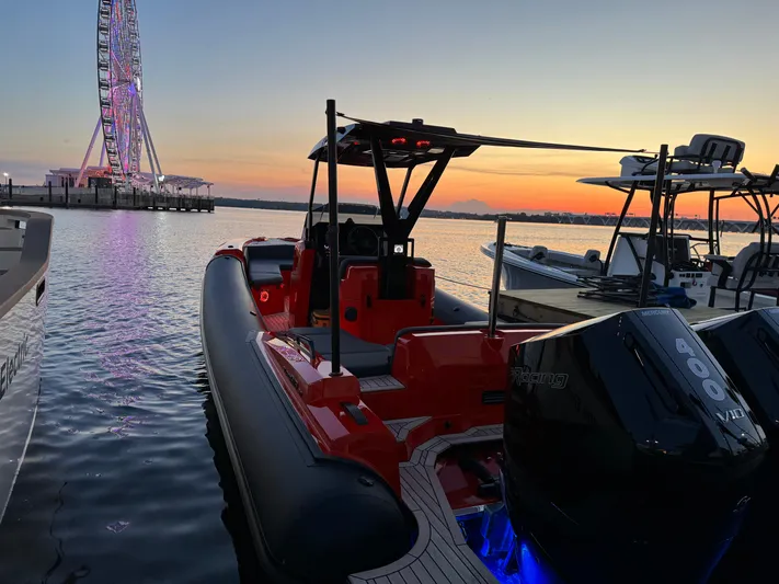  Yacht Photos Pics SuperRib Open 30 boat docked at sunset with Ferris wheel in background, 2024 model.