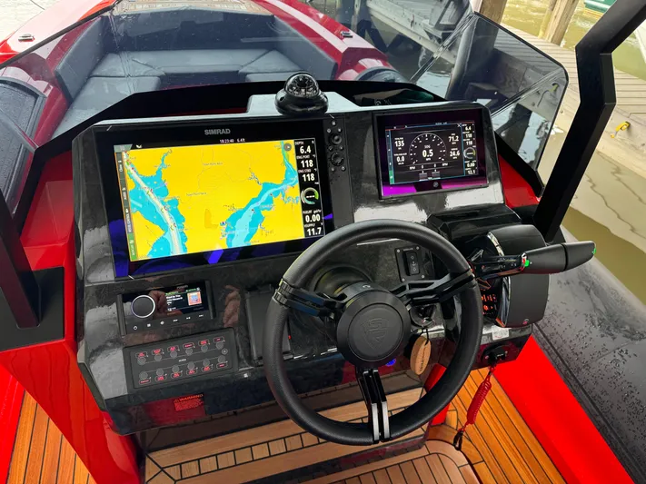  Yacht Photos Pics Control panel of the 2024 SuperRib Open 30 boat with navigation screens.