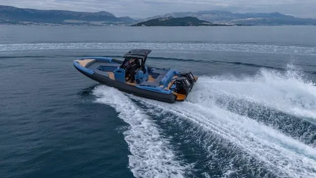  Yacht Photos Pics 2025 SuperRib Open 30 speedboat cruising on open water with scenic island backdrop.