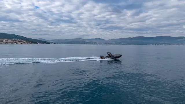  Yacht Photos Pics 2025 SuperRib Open 30 boat cruising on calm sea under cloudy sky.