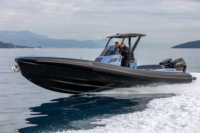  Yacht Photos Pics 2025 SuperRib Open 30 speeding on water, sleek design, two passengers, scenic backdrop.