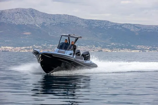  Yacht Photos Pics 2025 SuperRib Open 30 speedboat cruising on water with mountainous backdrop.