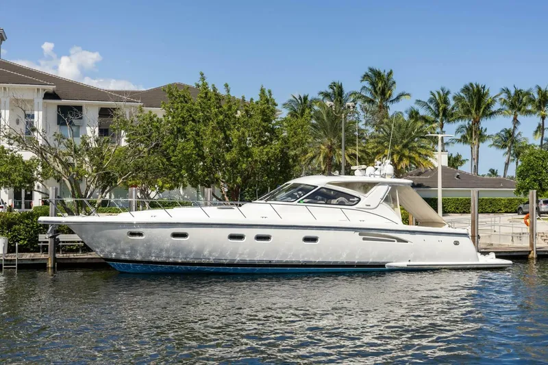  Yacht Photos Pics 2000 Tiara Yachts 5200 Express docked by palm trees and waterfront homes.