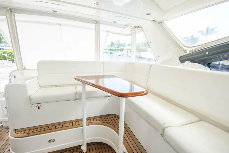  Yacht Photos Pics Luxurious interior of 2000 Tiara Yachts 5200 Express with white seating and wooden table.