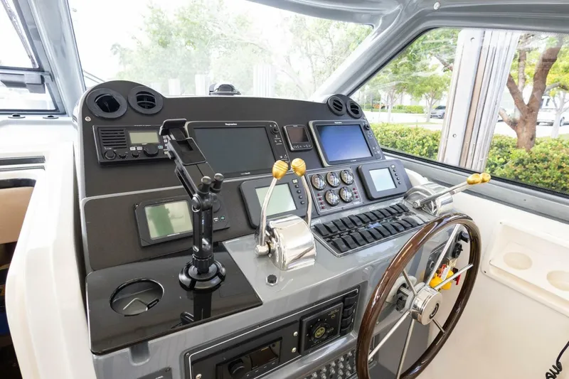  Yacht Photos Pics Control panel of a 2000 Tiara Yachts 5200 Express, featuring navigation and steering equipment.