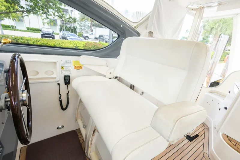  Yacht Photos Pics Interior of 2000 Tiara Yachts 5200 Express with white captain's seat and steering wheel.