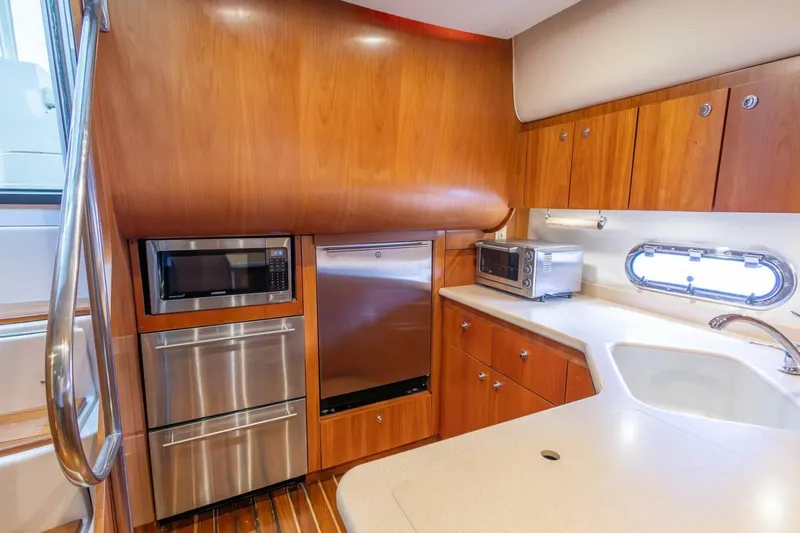  Yacht Photos Pics Luxurious 2000 Tiara Yachts 5200 Express kitchen with wood cabinetry and modern appliances.