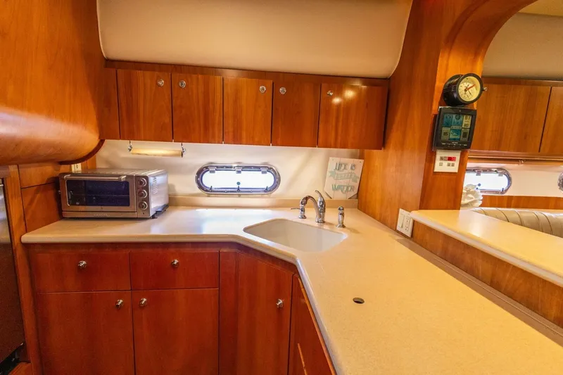  Yacht Photos Pics Luxurious 2000 Tiara Yachts 5200 Express kitchen with wood cabinetry and modern appliances.