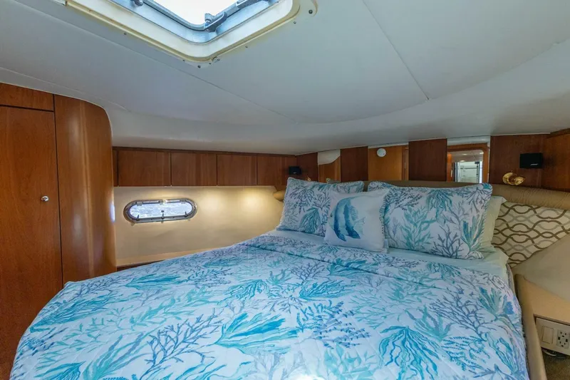  Yacht Photos Pics Luxurious cabin interior of 2000 Tiara Yachts 5200 Express with elegant bedding.