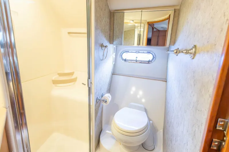  Yacht Photos Pics Bathroom interior of 2000 Tiara Yachts 5200 Express, featuring shower and toilet.