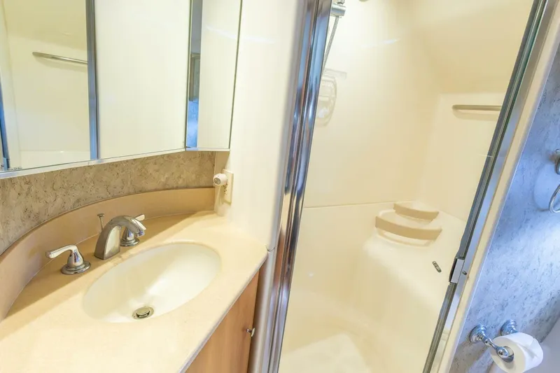  Yacht Photos Pics Luxurious bathroom in 2000 Tiara Yachts 5200 Express, featuring a sleek sink and shower.