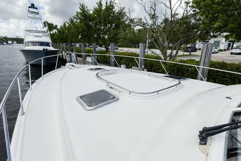  Yacht Photos Pics 2000 Tiara Yachts 5200 Express docked, showcasing sleek deck design and marina setting.