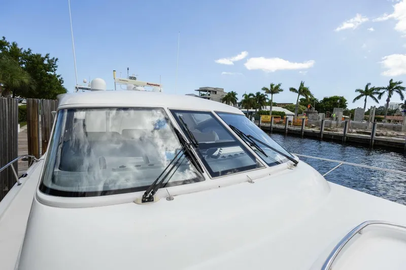  Yacht Photos Pics 2000 Tiara Yachts 5200 Express docked near palm trees and waterfront.