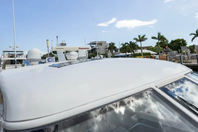  Yacht Photos Pics 2000 Tiara Yachts 5200 Express with Raymarine equipment, docked near palm trees.