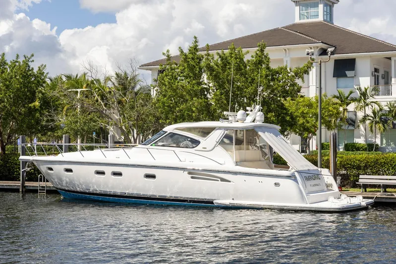  Yacht Photos Pics 2000 Tiara Yachts 5200 Express docked near a waterfront building.