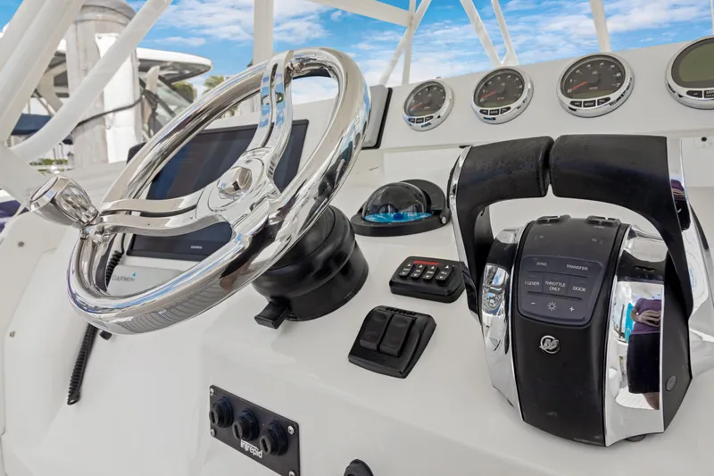  Yacht Photos Pics 2004 Intrepid 377 Walkaround boat dashboard with steering wheel and controls.