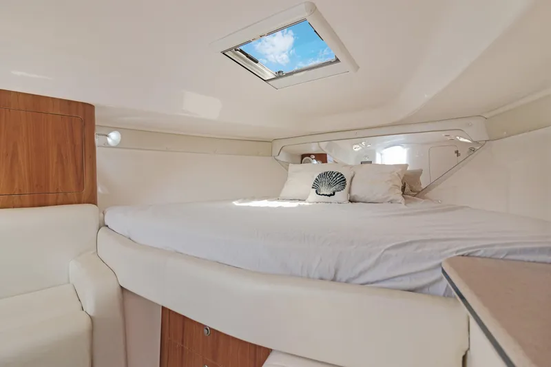  Yacht Photos Pics Luxurious cabin interior of 2004 Intrepid 377 Walkaround with skylight and cozy bedding.