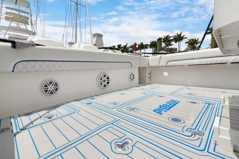  Yacht Photos Pics 2004 Intrepid 377 Walkaround boat deck with custom flooring and speaker system.