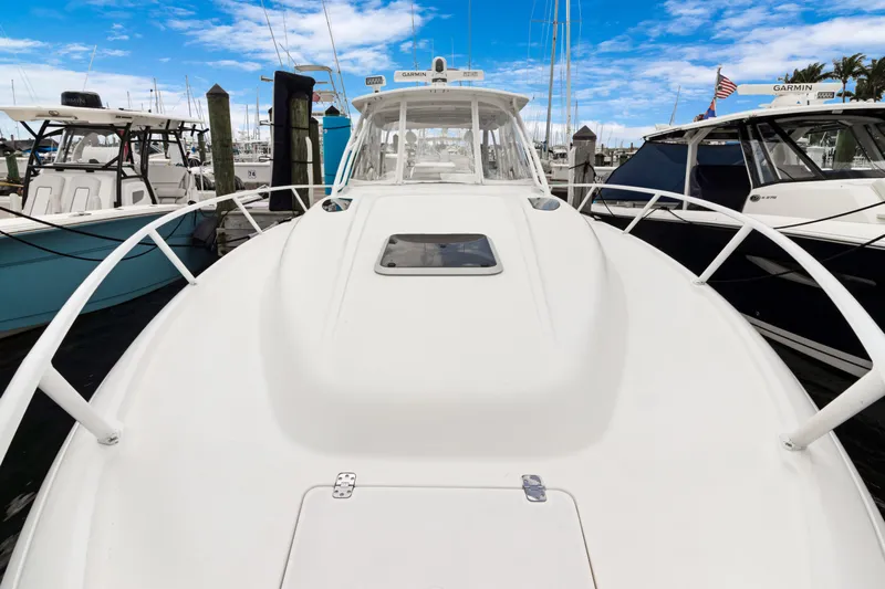  Yacht Photos Pics 2004 Intrepid 377 Walkaround boat docked at marina under blue sky.
