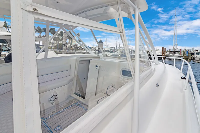  Yacht Photos Pics 2004 Intrepid 377 Walkaround boat docked at marina, featuring spacious deck and clear skies.