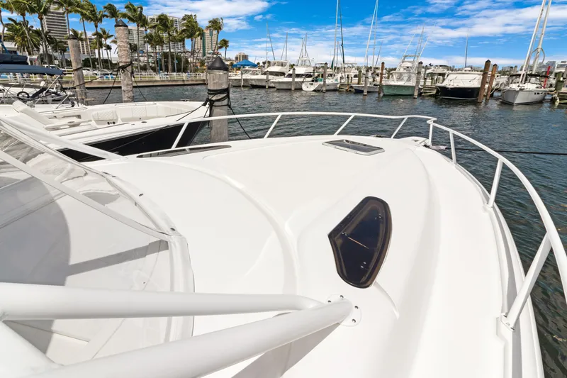  Yacht Photos Pics 2004 Intrepid 377 Walkaround boat docked in a marina with clear skies.