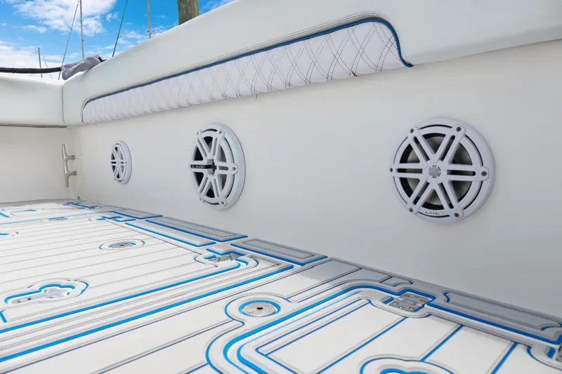  Yacht Photos Pics 2004 Intrepid 377 Walkaround boat interior with speakers and patterned flooring.