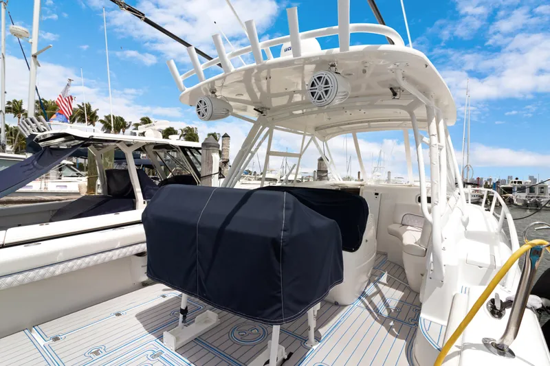  Yacht Photos Pics 2004 Intrepid 377 Walkaround boat docked, featuring covered seating and modern amenities.