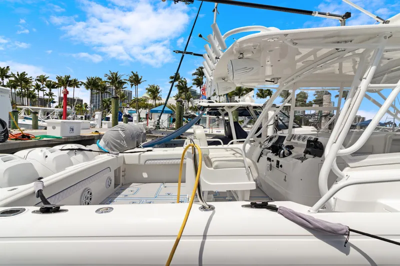  Yacht Photos Pics 2004 Intrepid 377 Walkaround boat docked at marina under clear blue sky.
